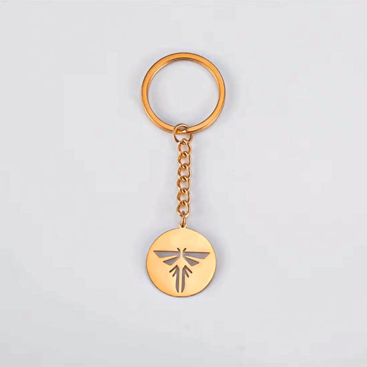 The Last of Us Retro Hollowed Firefly Logo Keychain Gold/Silver - Gold Available at 2Fast2See.co