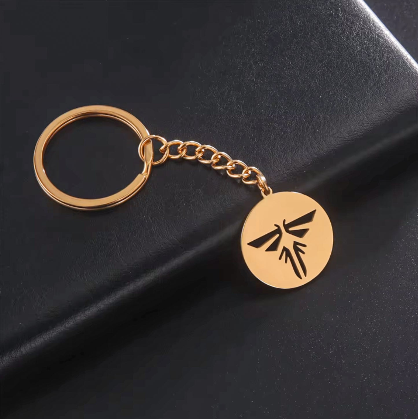 The Last of Us Retro Hollowed Firefly Logo Keychain Gold/Silver - Gold Available at 2Fast2See.co