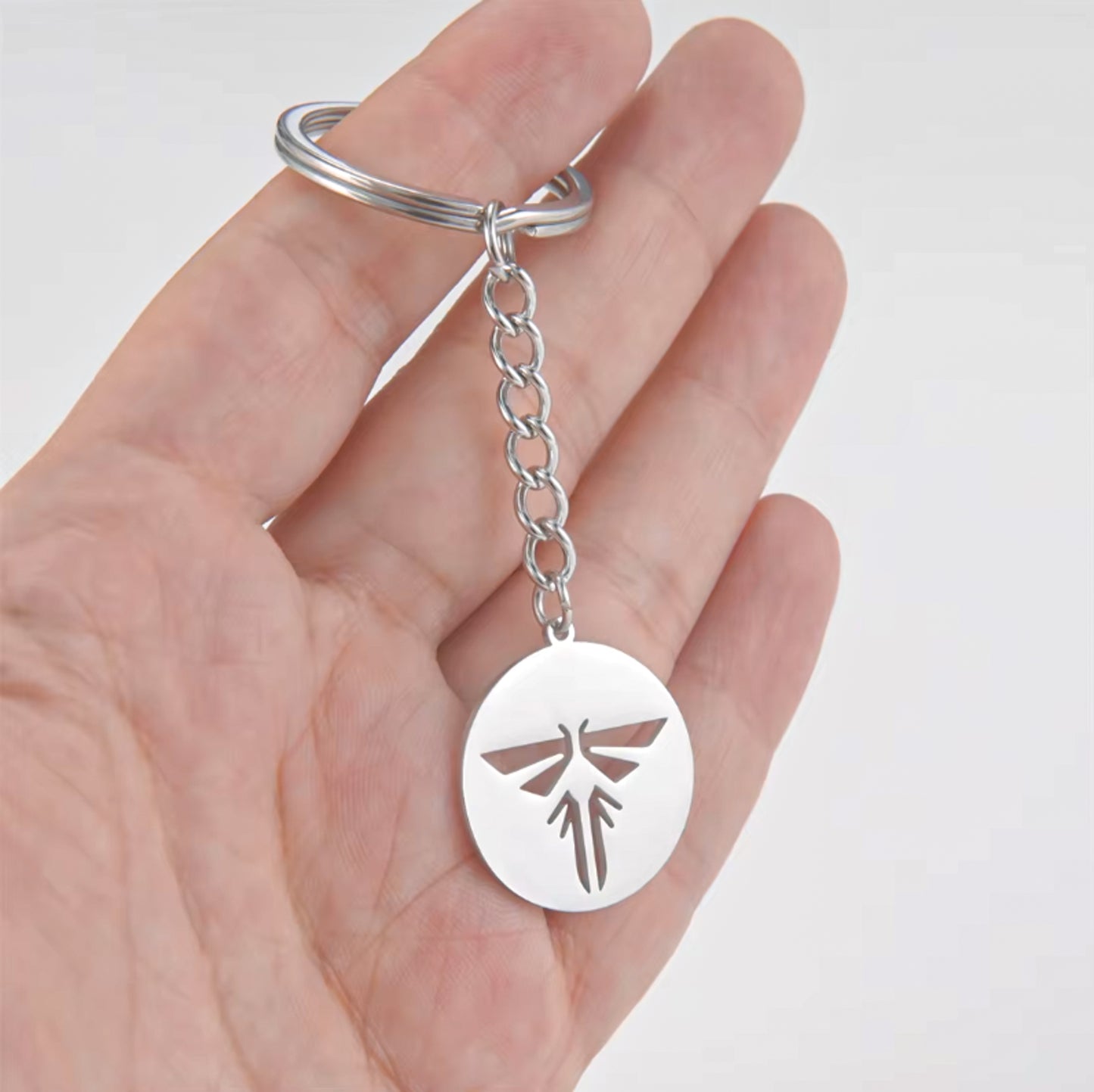 The Last of Us Retro Hollowed Firefly Logo Keychain Gold/Silver - Silver Available at 2Fast2See.co