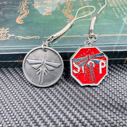 The Last of Us Firefly Charm Strap Keychains - Get Both on Sale Available at 2Fast2See.co