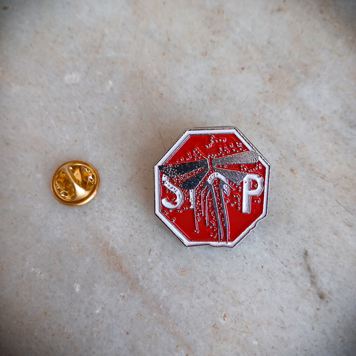 The Last of Us Metal Firefly Stop Sign Pin - Available at 2Fast2See.co